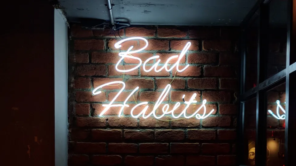 Bad habits neon sign