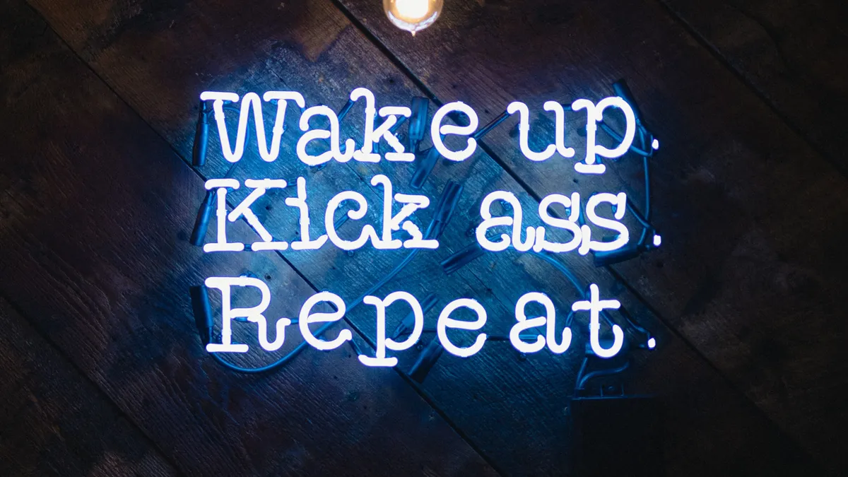 Wake up kick ass repeat neon sign